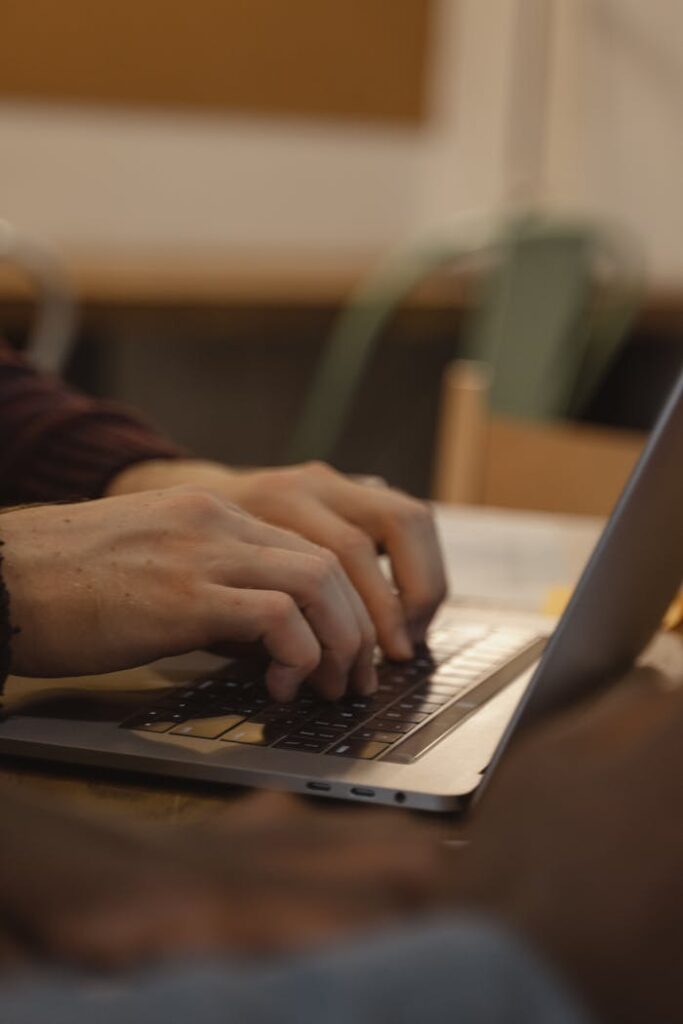 Close-up of Person Typing on Laptop